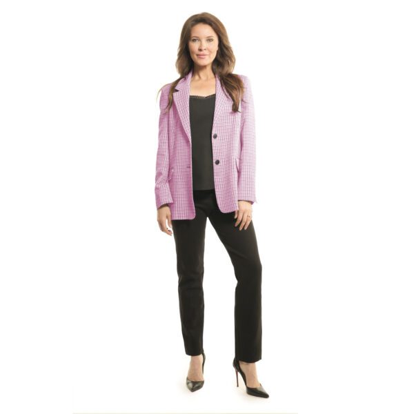 Woman wearing a pink blazer and black pants with heels.